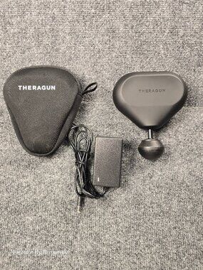 Therabody Theragun Mini portable percussion massage gun.